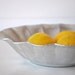 Hammered silver metal dish with scalloped edges and embossed flower