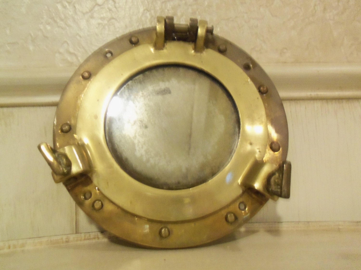 Antique brass nautical porthole mirror