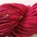 Hot and Silky. Hand spun art yarn. Pink and red with silk and sparkle.