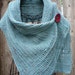 Turquoise buttoned wrap with a big red button. Very soft and comfy.