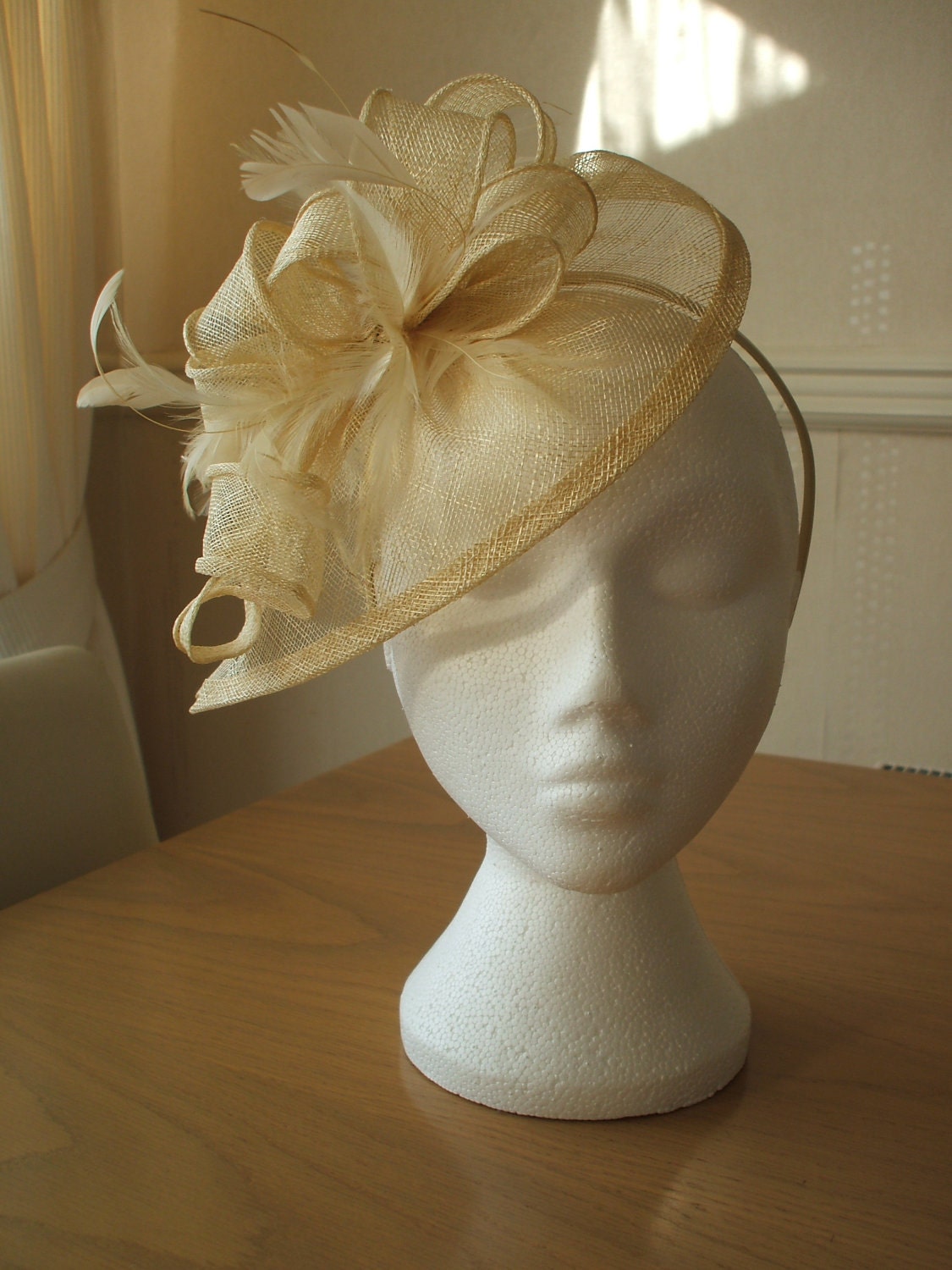 Champagne Gold Fascinator and Feather Fascinator on a