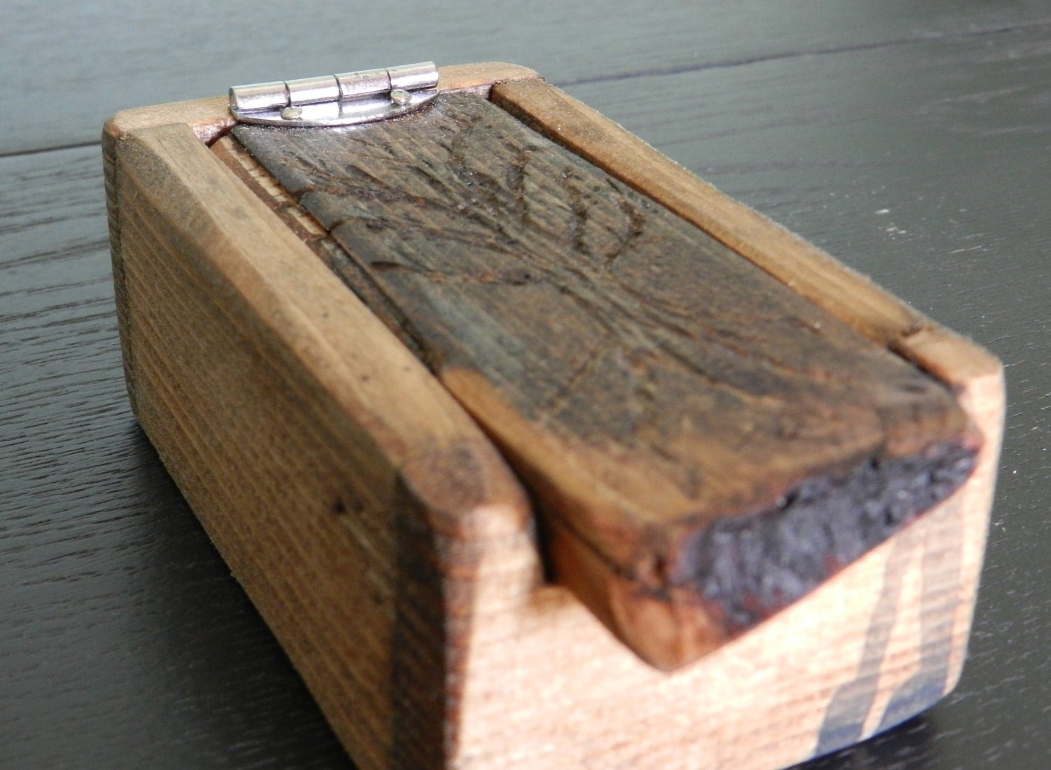 small rustic wooden box with carved tree