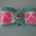 Seafoam green and pink heart motif hand knit coffee cup cosy