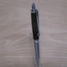30 Caliber bullet click pen made with Teak from the USS NC