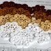 Floral motifs. Set of 16 crochet flower appliques. White, beige, gold and brown colors.