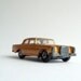 Luxury in a small vintage toy car, a gold Superfast Mercedes 300, made in England