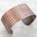 Copper cuff with knitted pattern