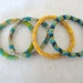 Set of 4 gorgeous beaded bracelets - green, yellow, blue, golden and rainbow black beaded bracelets