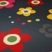 green, yellow, red, and pink flowered floorcloth - canvas art for your floor - charcoal gray