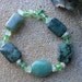 Green beaded stretch bracelet with jade, faceted crystals, jasper and prehnite chips