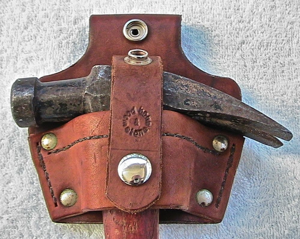 Leather hammer holster with security strap. by WoodBoneAndStone