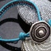 D2E single wrap picasso glass beas hand loomed onto teal leather bracelet with antique silve tone button clasp