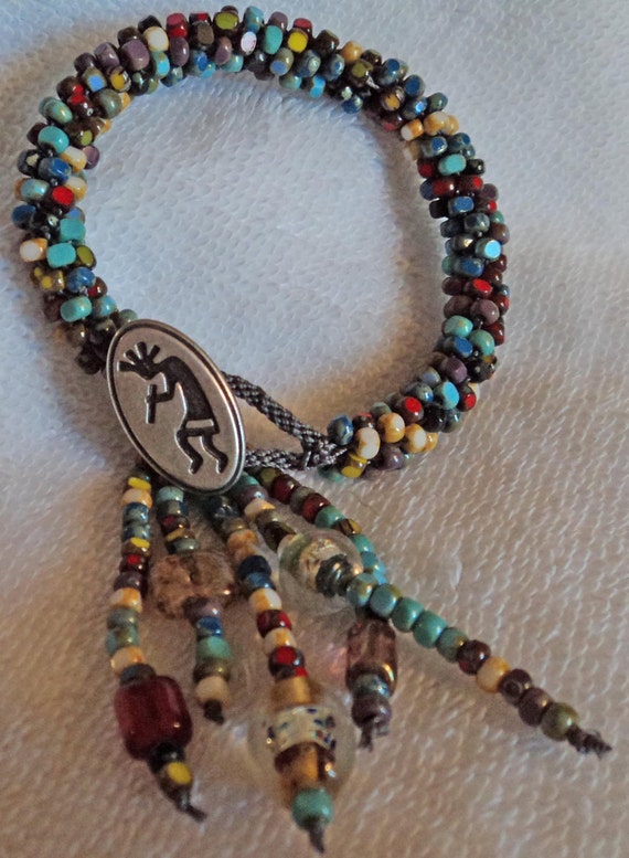 Picasso Kumihimo bracelet with a Kokopelli button