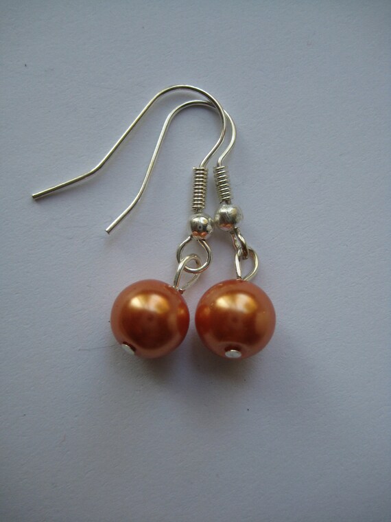 Items similar to Orange Pearl Earrings on Etsy