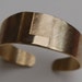 Chunky gold cuff bracelet with monogram L