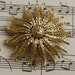 large goldtone metal flower brooch