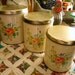 Vintage Decoware Tin Cannisters from the 1960s with Orange & Yellow Flowers, Very Well Used, Set of Three