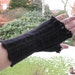 Fingerless mittens knitted with black QIVIUT