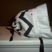 Fun baby bonnet. Bold black and white zig zag bonnet. Wide white rufffle and tied with a satin ribbons