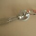 1960s hand egg beater with pastel pink handle