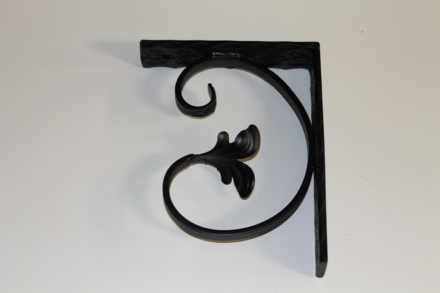 Wrought iron shelf support bracket