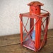 Hanging red candle lantern with glass panes