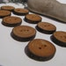 Nine wood buttons made of Apple wood in BC, Canada. 1" round. Scarves, cowls or just about any fibre art project.