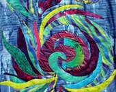 Wall decor abstract art wall hanging featuring a pieced spiral in purple blue teal lime green