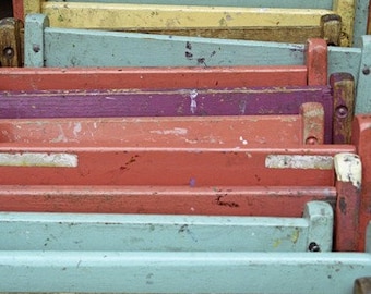 A Stack  of Pastel Folding Chairs Leaning Against the Wall. Fine Art Photo