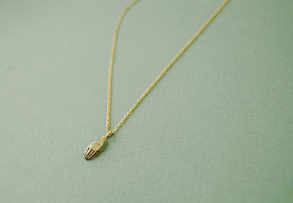 Tiny golden hand necklace
