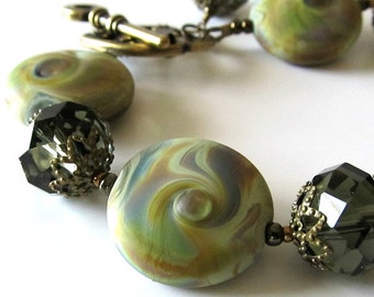 NOW ON SALE Was 105 now 90 Lampwork Beaded Bracelet Olive Green Crystals Antique Brass Beaded jewelry Beaded bracelet Key Clasp