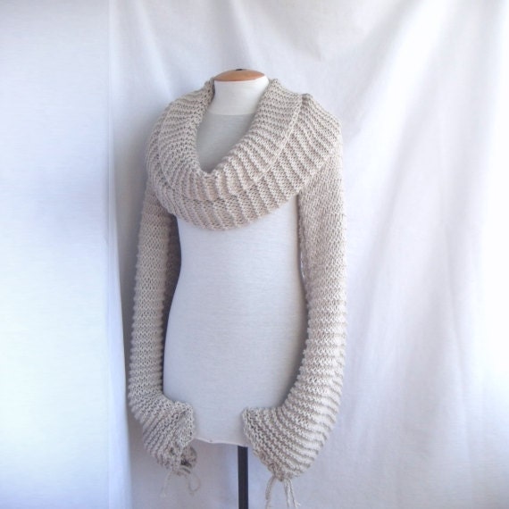 Bolero shawl scarf with sleeves at both ends in light beige.