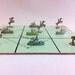Monopoly tic tac toe game. Soldiers on horses vs battleships. From vintage game token pieces and real board game.