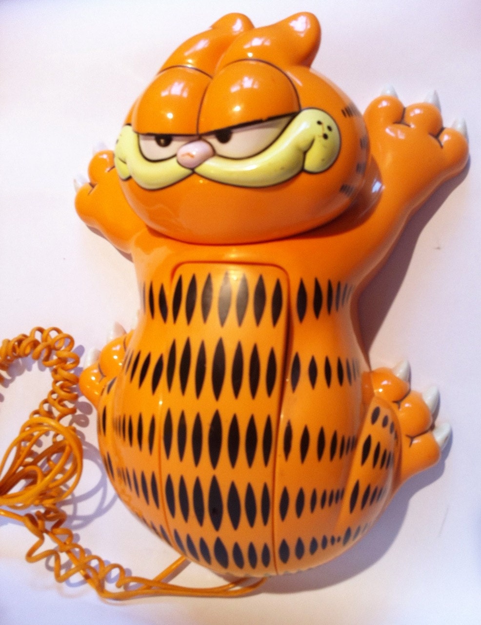 Vintage Garfield push button phone. Retro orange telephone.