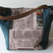 newspaper print handbag, petrol blue shoulder bag with newspaper print middle part, shoulder handles, over the arm handles, autumn bag