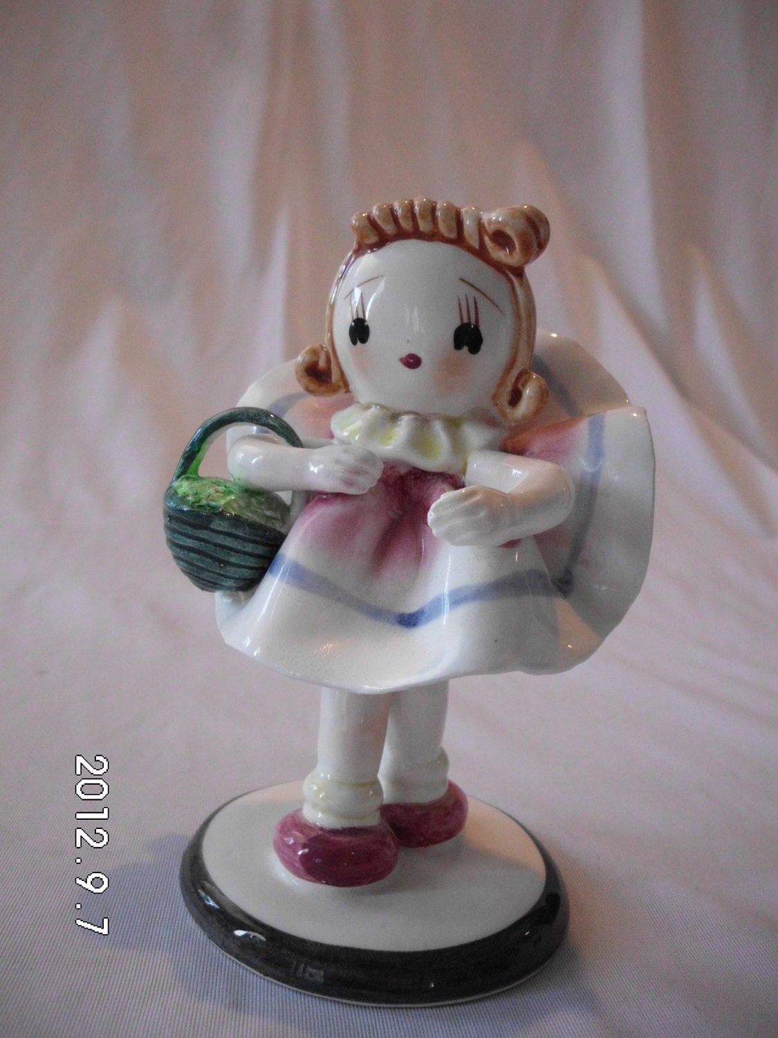 1950's Porcelain figurine of a little girl holding a