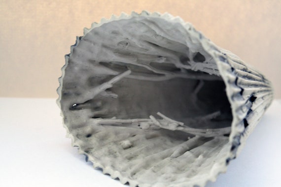 Corrugated ceramic cone shape piece with burnt by madebymanos