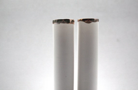 Thin tall tube vase made out of stoneware fine bone by madebymanos