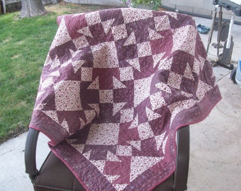 Quilted wall hanging or lap quilt. Machine pieced and quilted in beautiful burgandy colors