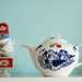 Large sized flock of birds and colorful dots teapot
