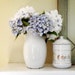 vintage French enamelware pitcher, white enamel jug with cobalt blue rim and black handle