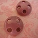 Vintage mauve pink round wheel design plastic shank buttons. Wholesale lot set of 2.