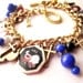 Vintage Regal Assembled LEO Multi Charm Bracelet - gold, brass, red, black, white, blue