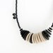 asymmetric chic necklace with beige and black circles and beads