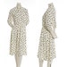 Vintage cream dress with tear-shaped polka dots and ruffle collar, tie at neck