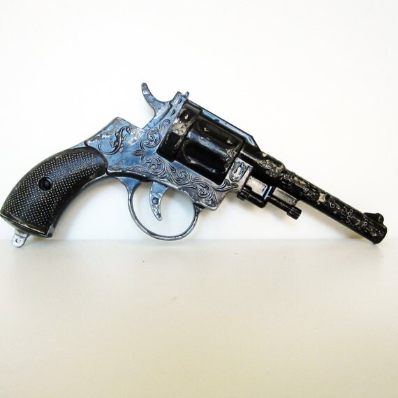 Vintage metal toy pistol use for mixed media art shadow