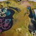 Discharged, dyed and silk screened man's medium t-shirt, guitars, hands, gears,pocket watches, and bicycles
