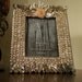 Picture frame with abalone shell pieces and coquina flower