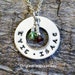 Custom mom or grandma family brag pendant necklace of stainless steel with Swarovski birth month crystals on a silver plated chain.