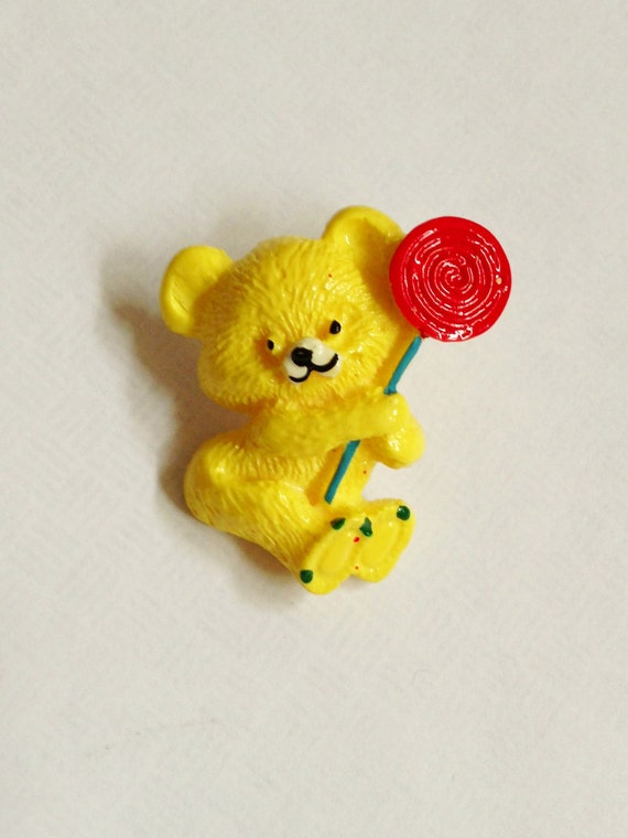 Adorable Vintage Plastic Yellow Teddy Bear Holding Lollipop